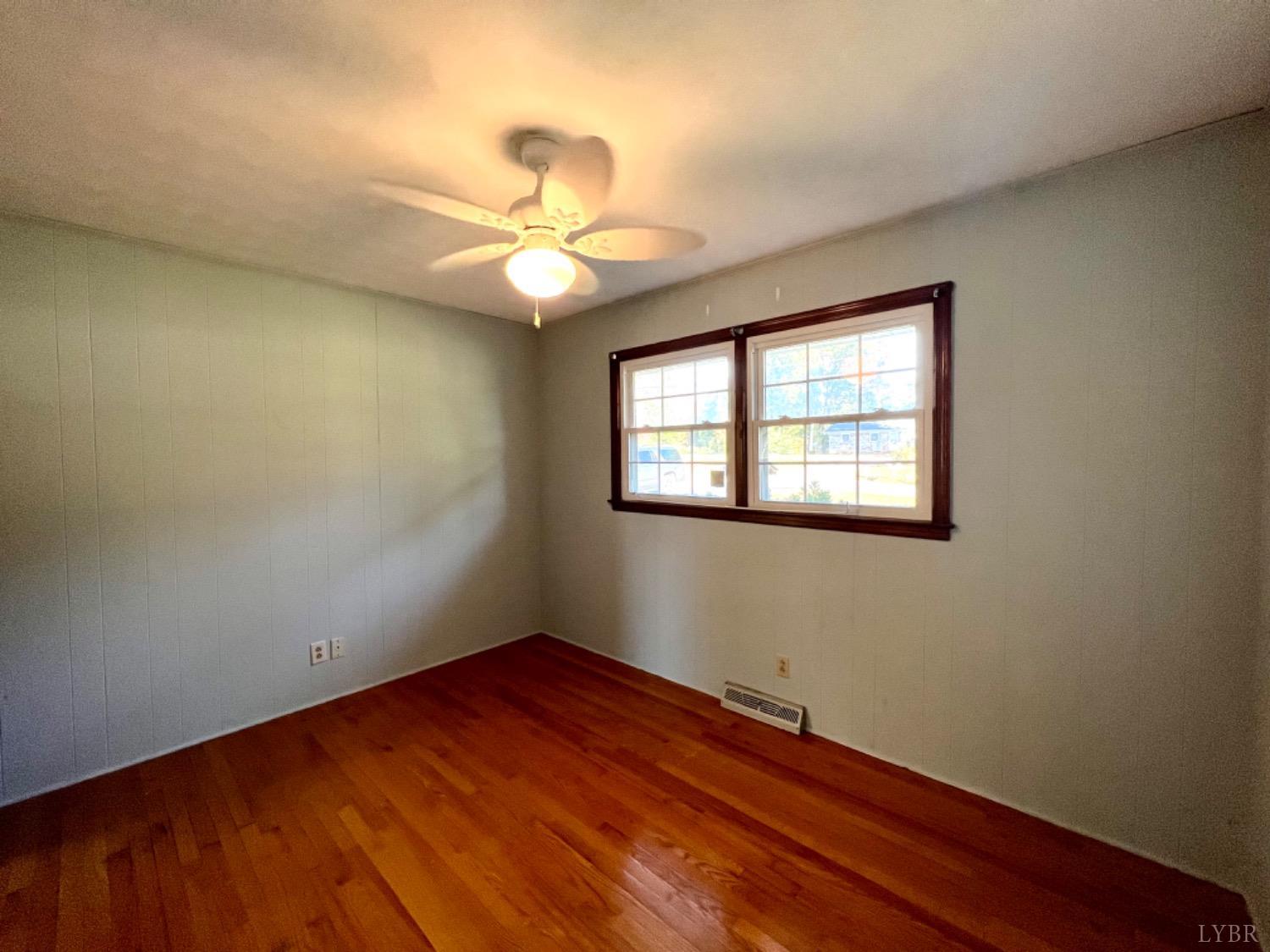 417 Jasper Wood Road Hurt, VA 24563 - Photo 13 of 36 wooden floor in an empty room with a window