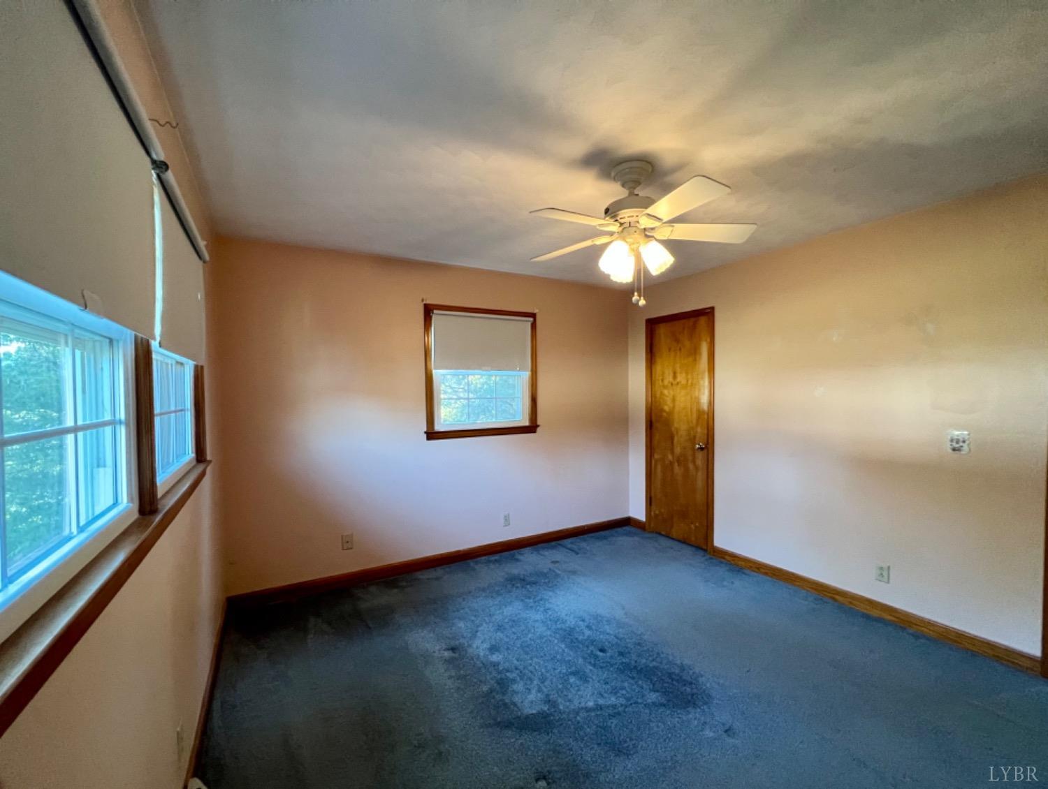 417 Jasper Wood Road Hurt, VA 24563 - Photo 5 of 36 an empty room with windows and fan