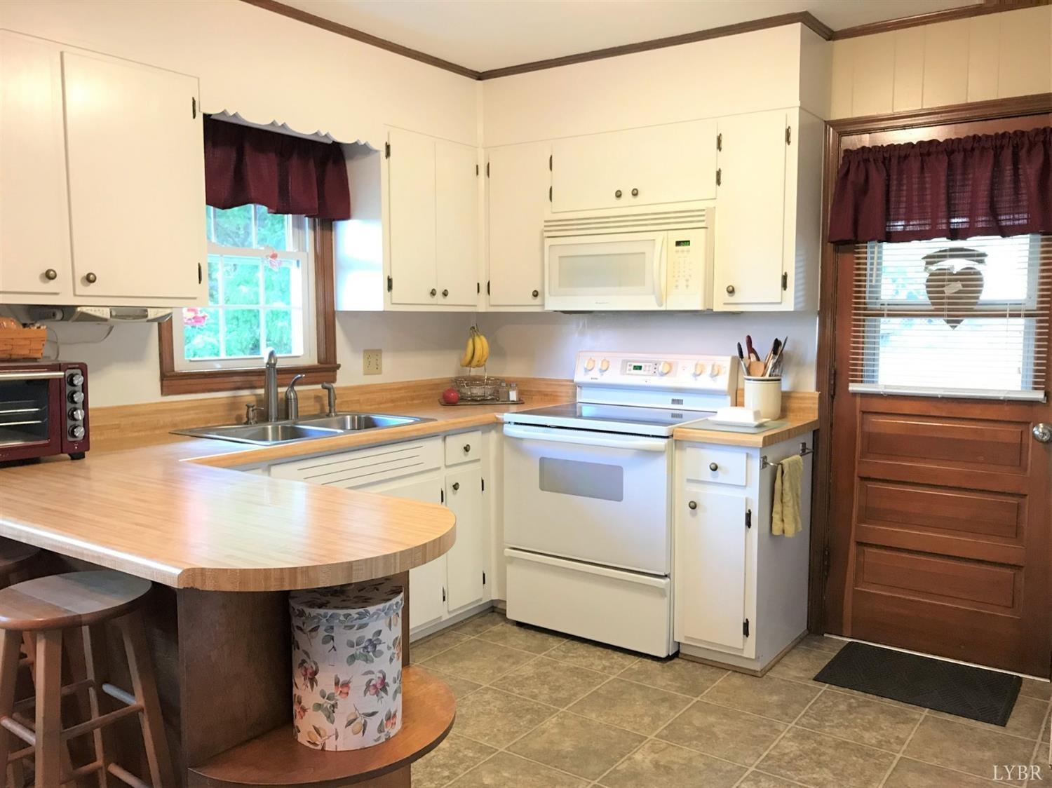 417 Jasper Wood Road Hurt, VA 24563 - Photo 6 of 36 a kitchen with a sink stove and cabinets