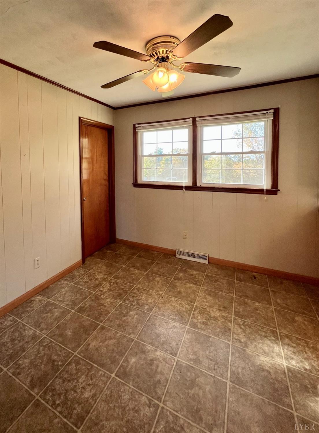 417 Jasper Wood Road Hurt, VA 24563 - Photo 7 of 36 an empty room with windows and fan