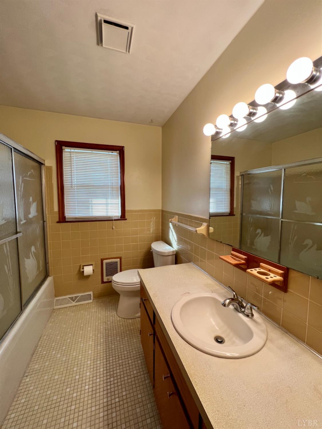 417 Jasper Wood Road Hurt, VA 24563 - Photo 9 of 36 a bathroom with a double vanity sink and a mirror