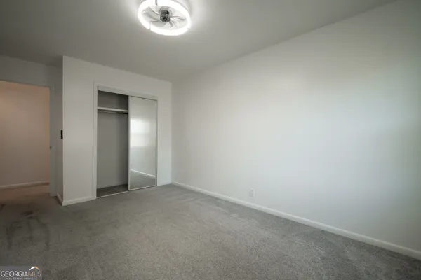 a kitchen with stainless steel appliances granite countertop a sink and a white cabinets