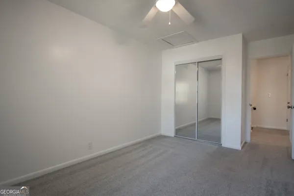 an empty room with wooden floor and a window