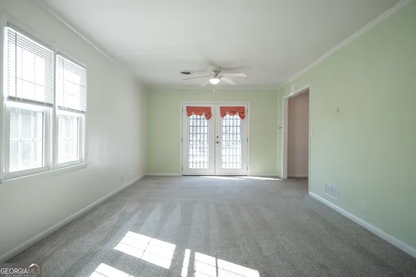 a bed sitting in a bedroom next to a window
