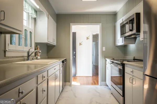 a white toilet sitting next to a bathroom sink