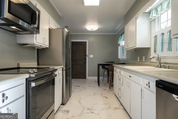 a view of a house with a yard and deck