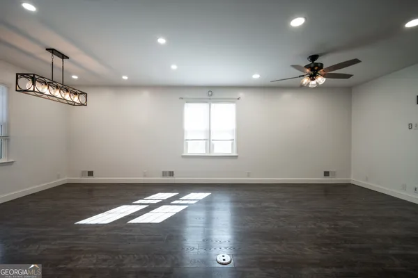 a kitchen with cabinets a sink dining table and chairs