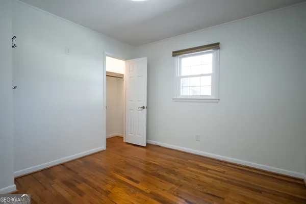 a backyard of a house with barbeque oven table and chairs