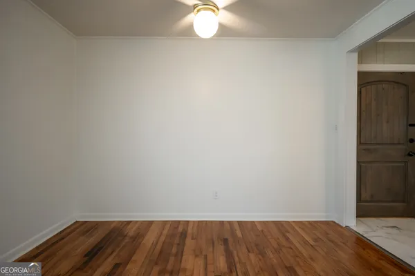 a view of a big house with a big yard and large trees