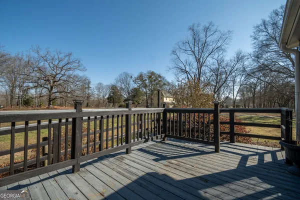a front view of house with yard and trees in the background