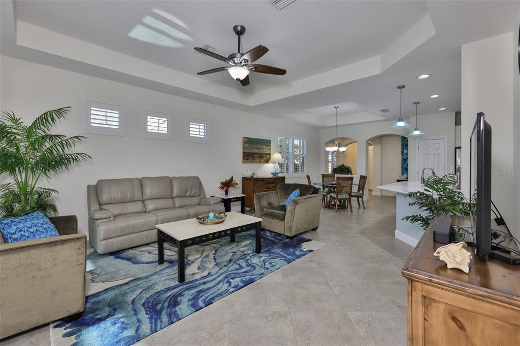 964 Pembroke Point Way Sun City Center, FL 33573 - Photo 11 of 66 a living room with furniture and a chandelier