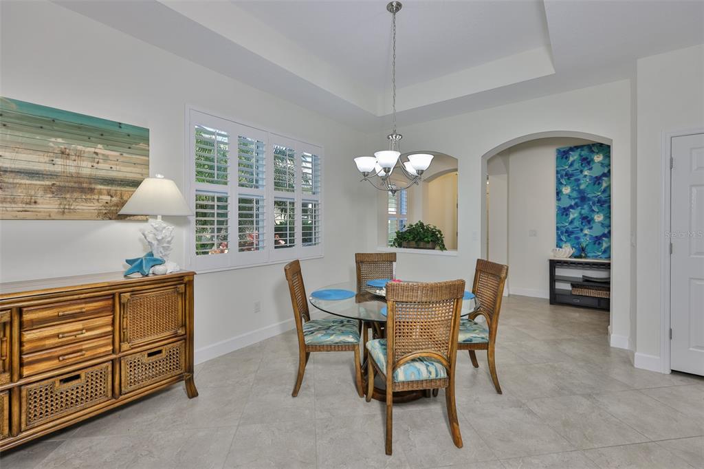 964 Pembroke Point Way Sun City Center, FL 33573 - Photo 12 of 66 a view of a dining room with furniture window and outside view