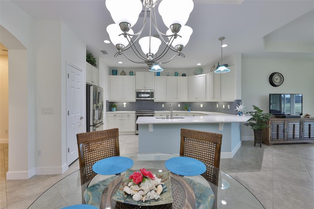 964 Pembroke Point Way Sun City Center, FL 33573 - Photo 14 of 66 a kitchen with cabinets a sink and appliances