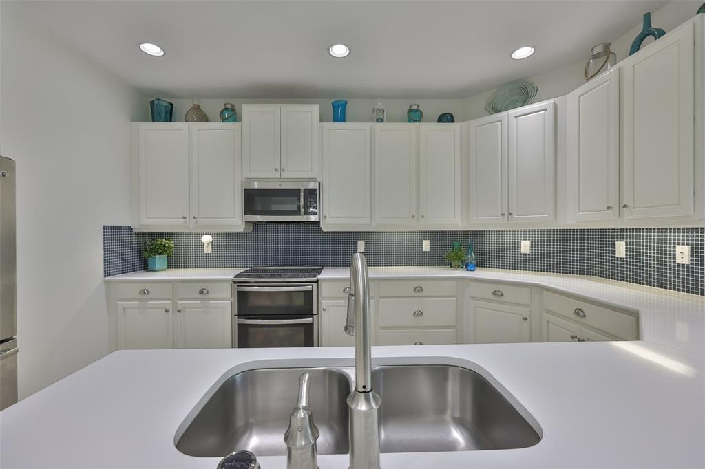 964 Pembroke Point Way Sun City Center, FL 33573 - Photo 16 of 66 a kitchen with granite countertop white cabinets and stainless steel appliances