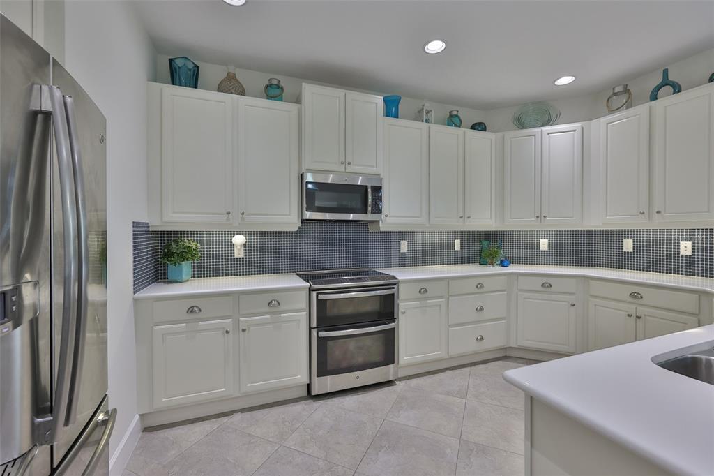 964 Pembroke Point Way Sun City Center, FL 33573 - Photo 17 of 66 a kitchen with cabinets appliances and a sink