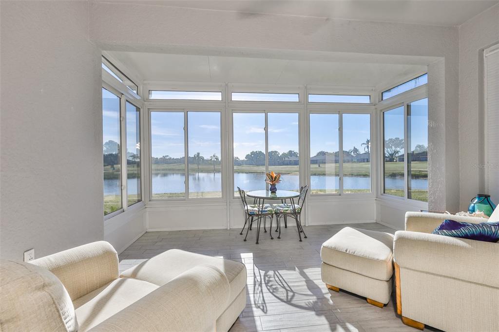 964 Pembroke Point Way Sun City Center, FL 33573 - Photo 20 of 66 a living room with furniture and a large window