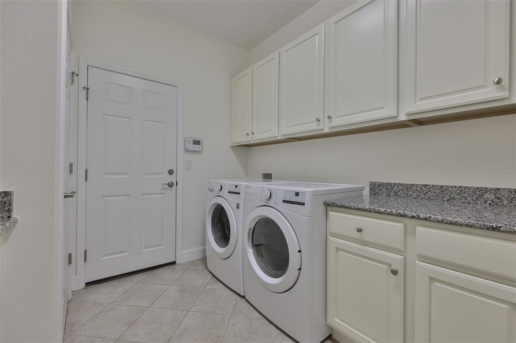 964 Pembroke Point Way Sun City Center, FL 33573 - Photo 26 of 66 a utility room with dryer and washer