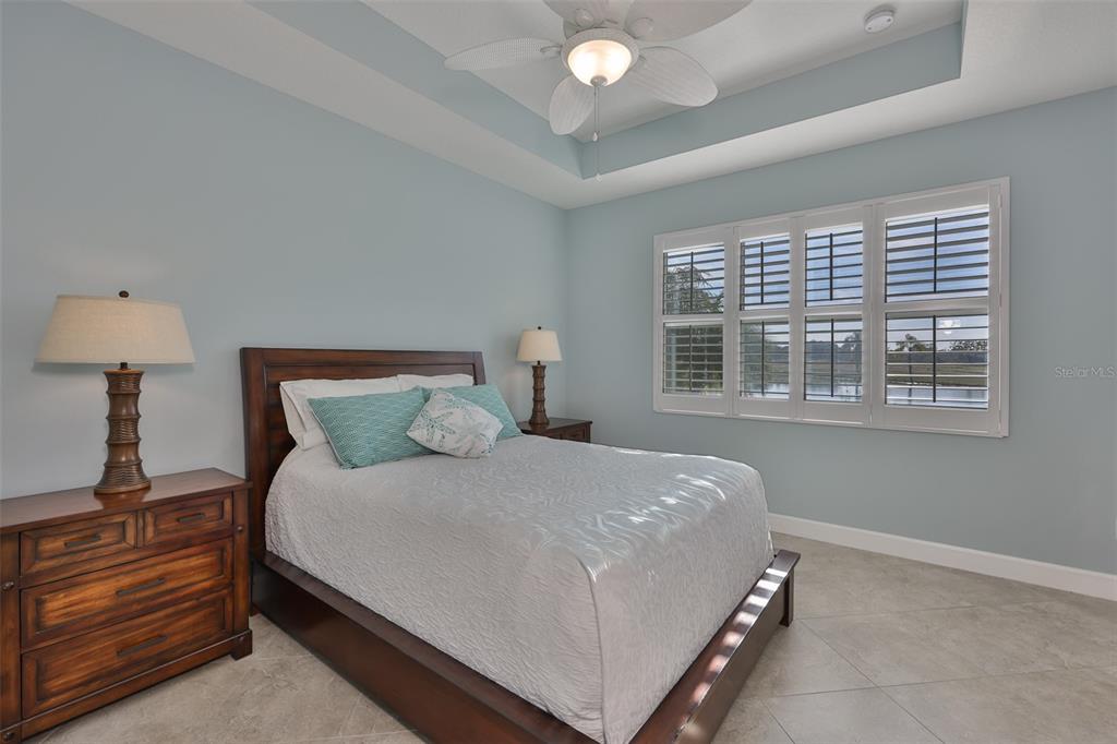 964 Pembroke Point Way Sun City Center, FL 33573 - Photo 27 of 66 a large bed sitting in a bedroom next to a window