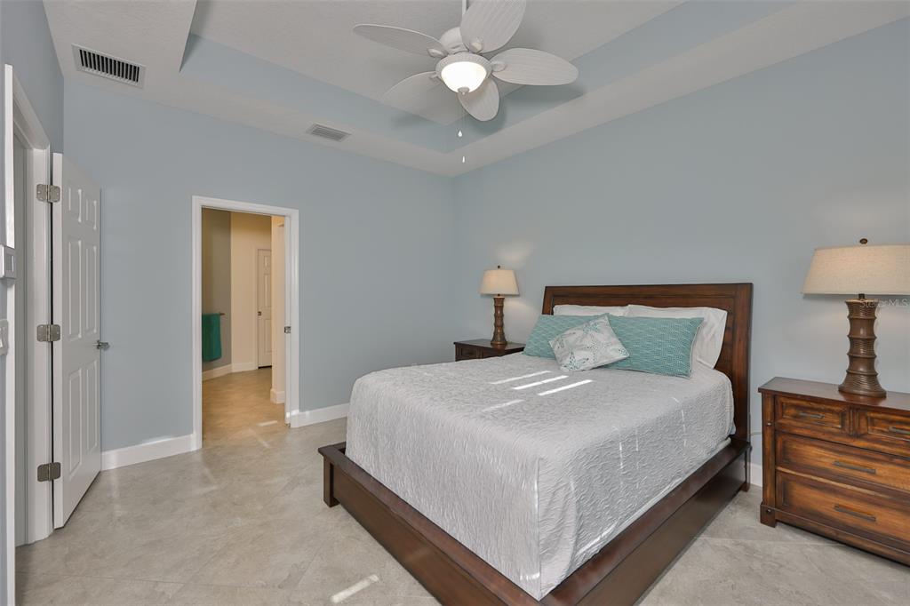 964 Pembroke Point Way Sun City Center, FL 33573 - Photo 30 of 66 a bedroom with a bed and a chandelier