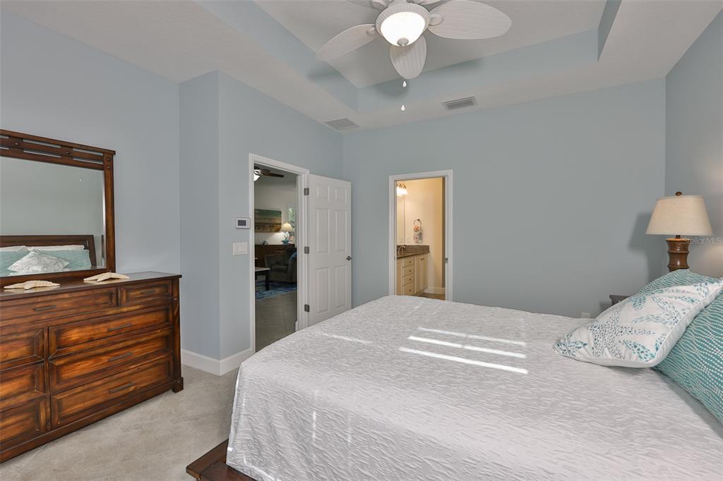 964 Pembroke Point Way Sun City Center, FL 33573 - Photo 31 of 66 a bedroom with a bed and a flat tv screen on dresser