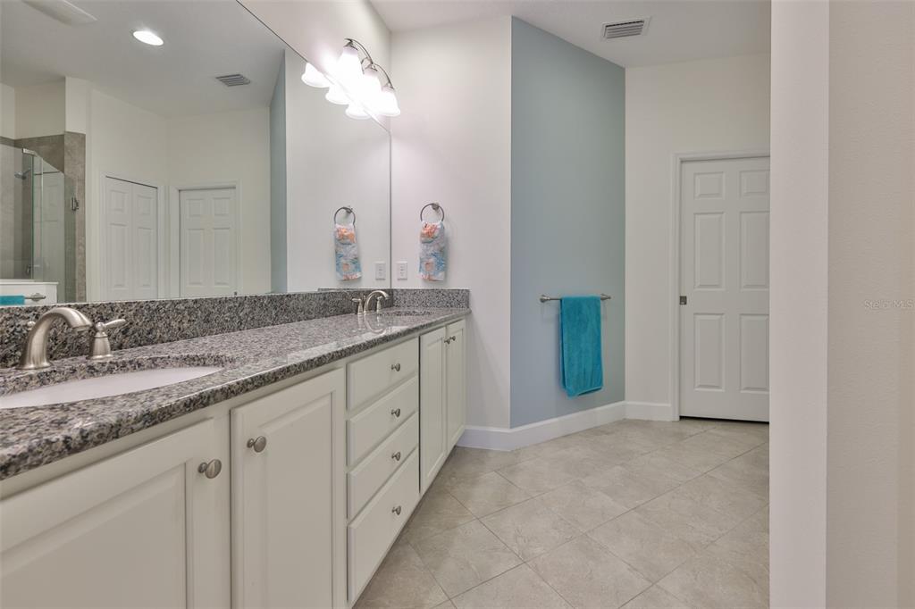 964 Pembroke Point Way Sun City Center, FL 33573 - Photo 32 of 66 a bathroom with a granite countertop sink and a mirror