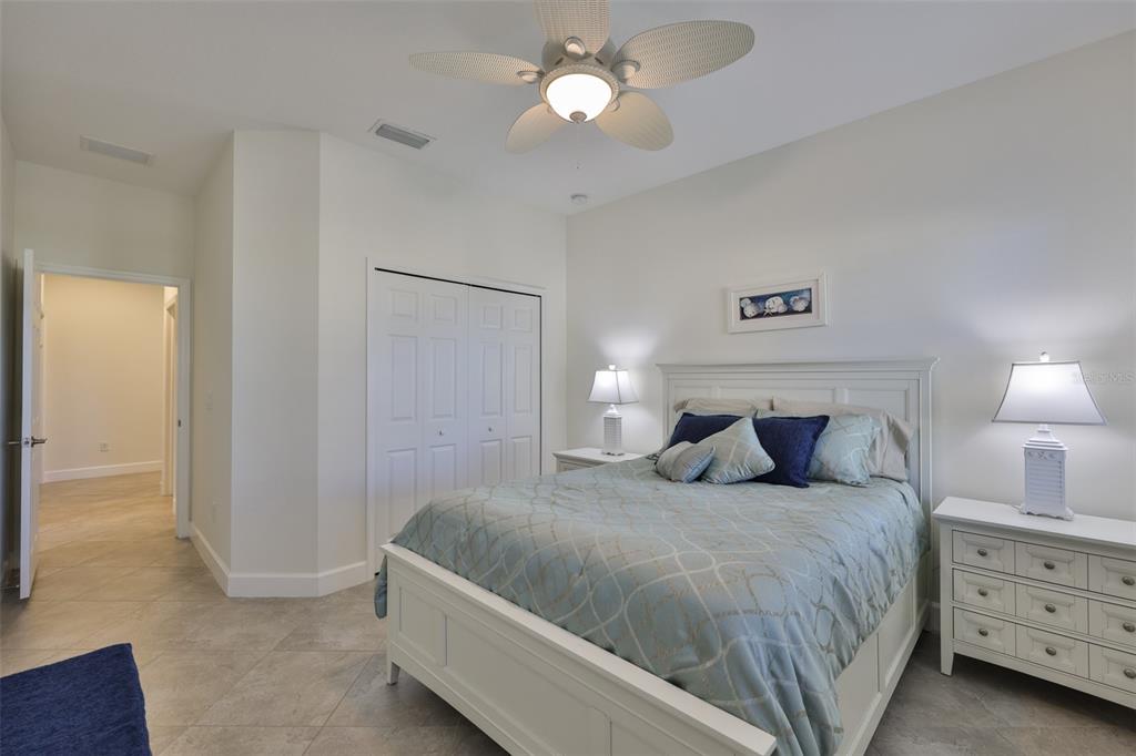 964 Pembroke Point Way Sun City Center, FL 33573 - Photo 35 of 66 a bedroom with a bed and a chandelier