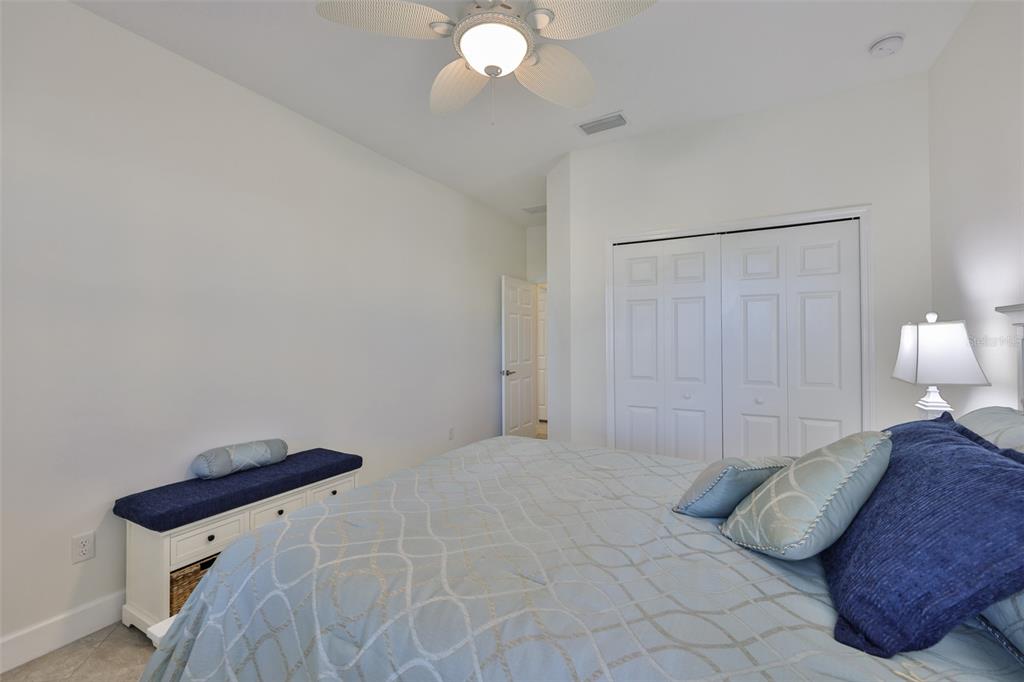 964 Pembroke Point Way Sun City Center, FL 33573 - Photo 36 of 66 a bedroom with a bed and a chandelier