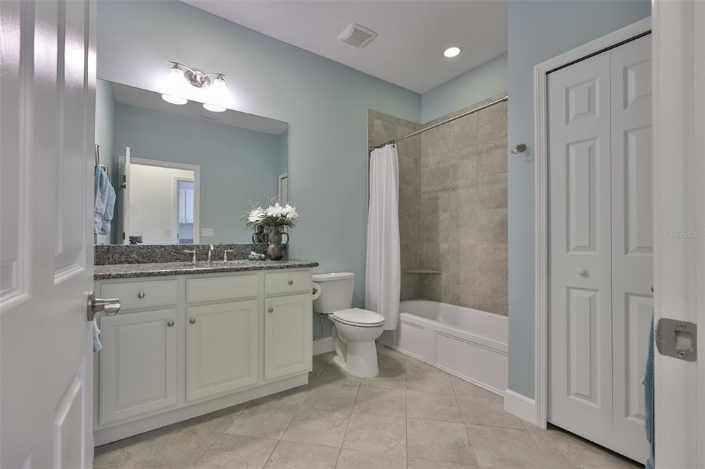 964 Pembroke Point Way Sun City Center, FL 33573 - Photo 37 of 66 a bathroom with a toilet a sink a tub and a mirror