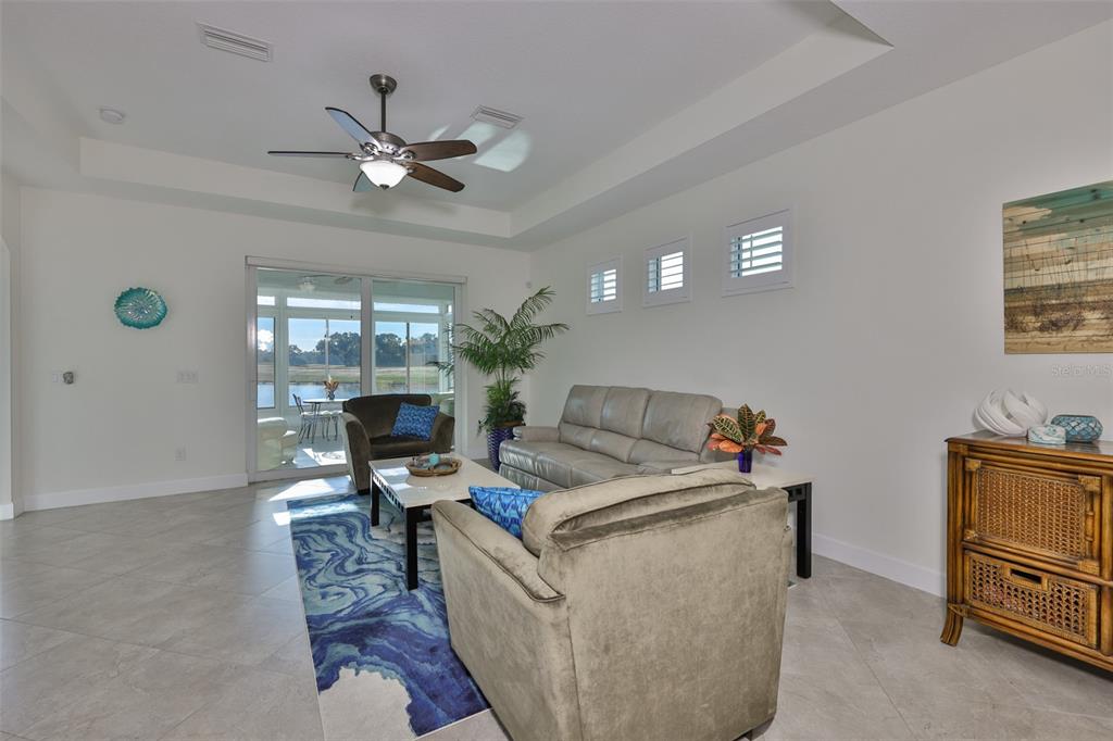 964 Pembroke Point Way Sun City Center, FL 33573 - Photo 8 of 66 a living room with furniture and a flat screen tv