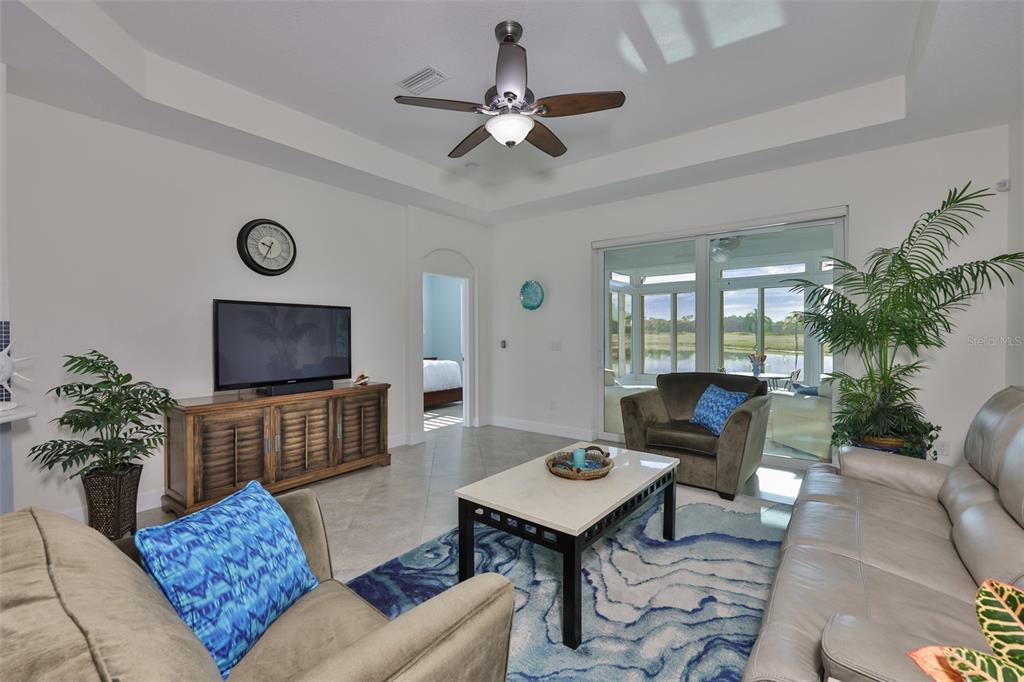964 Pembroke Point Way Sun City Center, FL 33573 - Photo 9 of 66 a living room with furniture a table and a potted plant