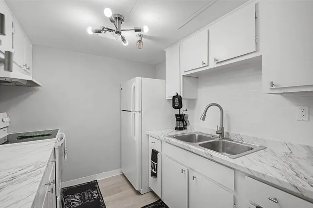 a living room with furniture a piano and a flat screen tv