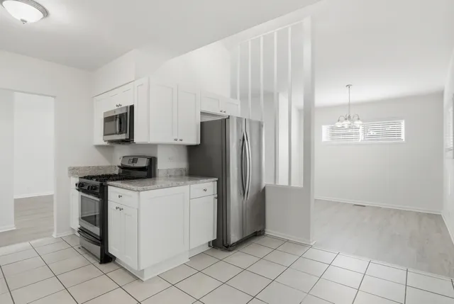 a kitchen with a stove a refrigerator and a sink