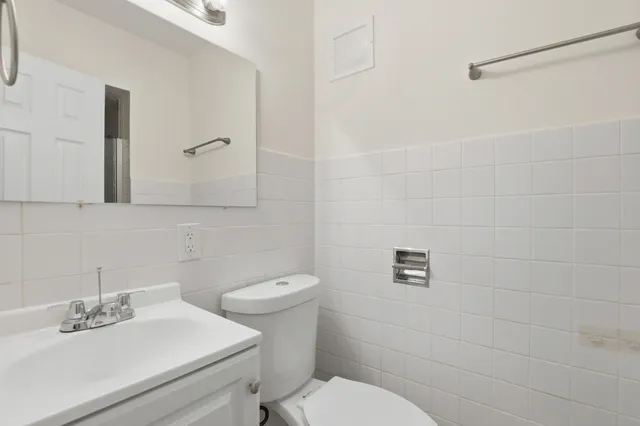 a bathroom with a sink mirror and toilet