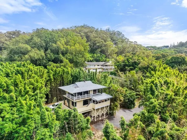 an aerial view of a house with yard and outdoor seating