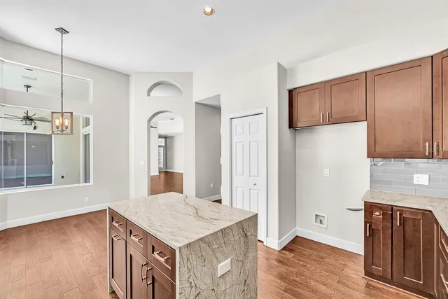 a kitchen with a sink refrigerator and cabinets