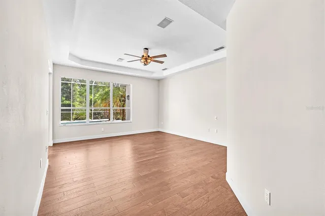 wooden floor in an empty room with a window