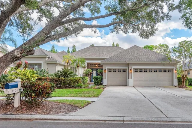 a front view of house with yard and green space