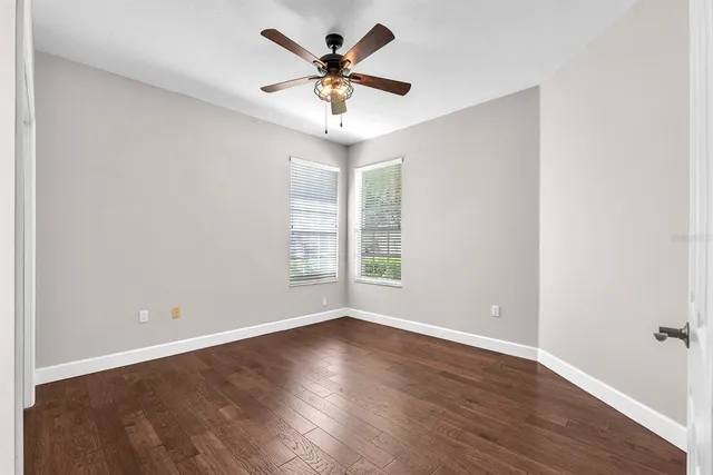 a bathroom with a granite countertop sink a toilet and mirror