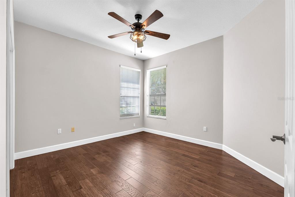 3504 Old Course Lane Valrico, FL 33596 - Photo 28 of 59 an empty room with wooden floor and windows