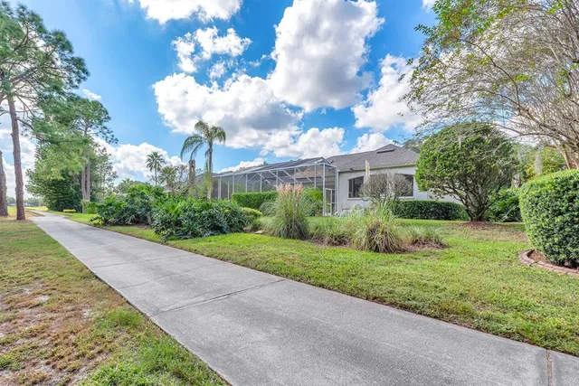 an aerial view of a house with a yard and lake view