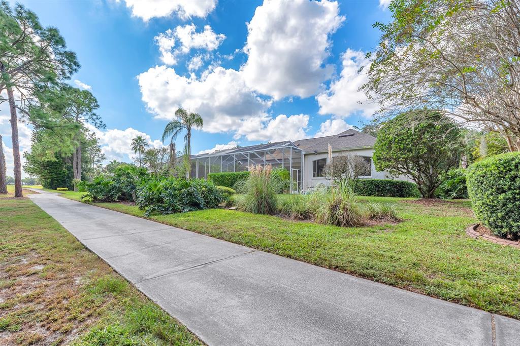 3504 Old Course Lane Valrico, FL 33596 - Photo 42 of 59 a view of a yard with flower plants and wooden fence