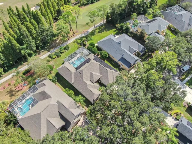 an aerial view of a house with a yard and lake view