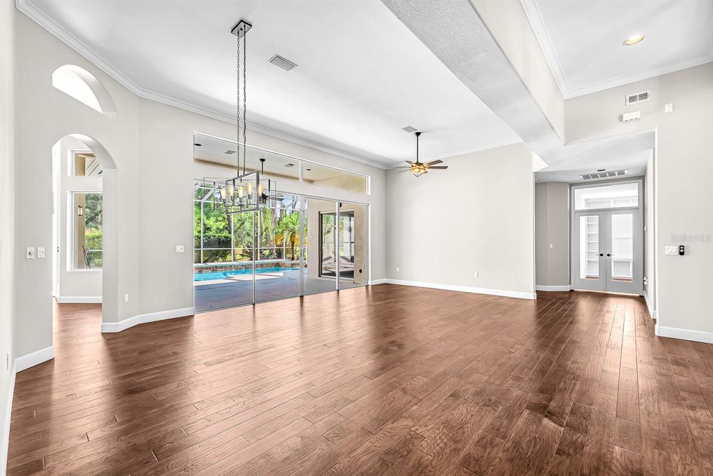 3504 Old Course Lane Valrico, FL 33596 - Photo 7 of 59 a view of an empty room with wooden floor and a window