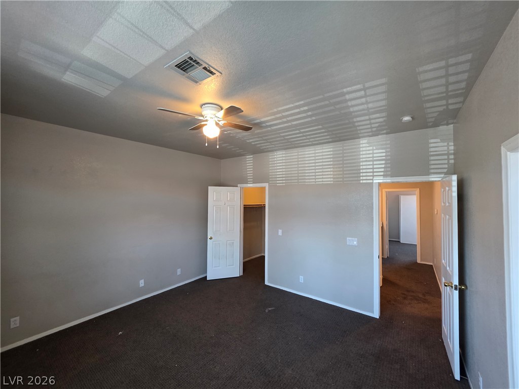 2275 Ramsgate Drive Henderson, NV 89074 - Photo 47 of 84 A comfortable bedroom with a ceiling fan and plush carpet, ready for personalization.