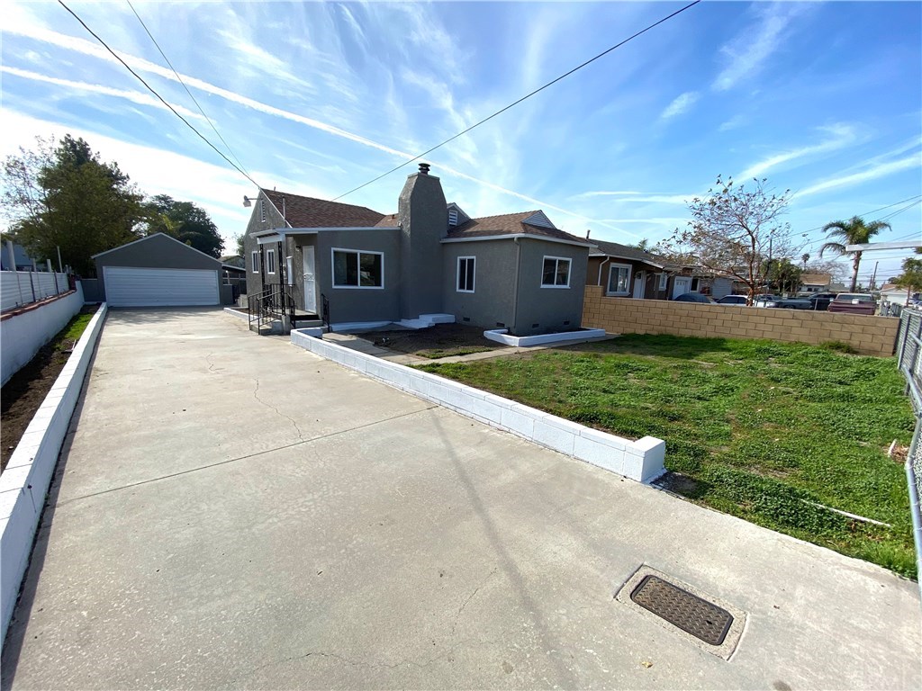 16757 Reed Street Fontana, CA 92336 - Photo 1 of 1 a front view of a house with garden