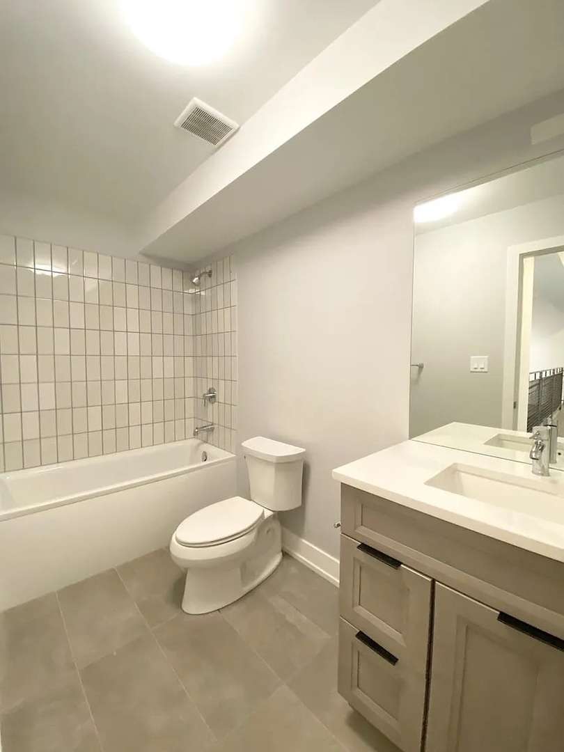 Undisclosed Address Chicago, IL 60640 - Photo 14 of 16 a bathroom with a sink a toilet and shower