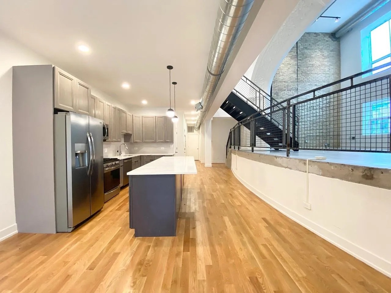 Undisclosed Address Chicago, IL 60640 - Photo 6 of 16 a large kitchen with stainless steel appliances kitchen island a large counter top and a sink