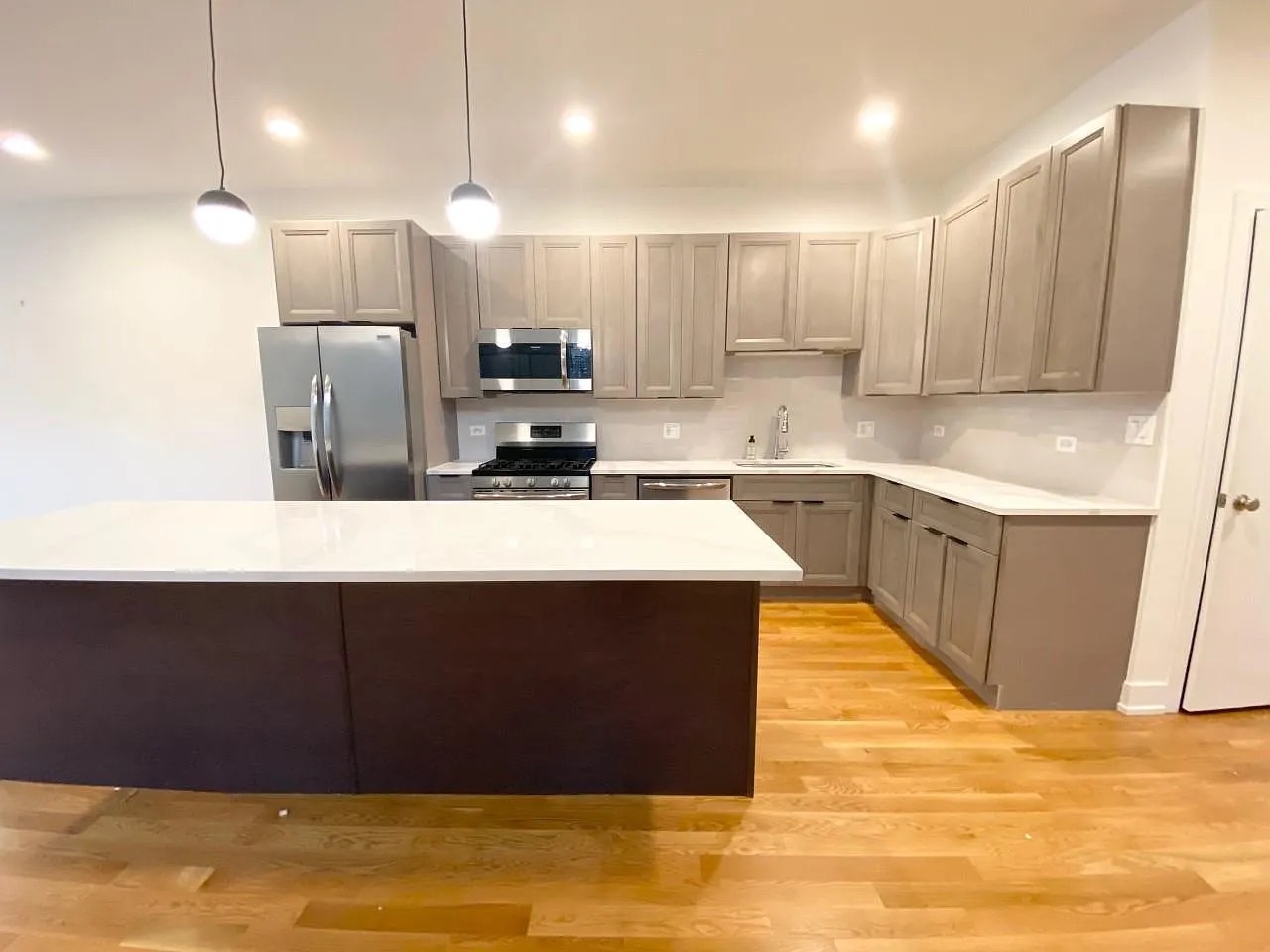 Undisclosed Address Chicago, IL 60640 - Photo 7 of 16 a kitchen with kitchen island a sink stainless steel appliances and cabinets