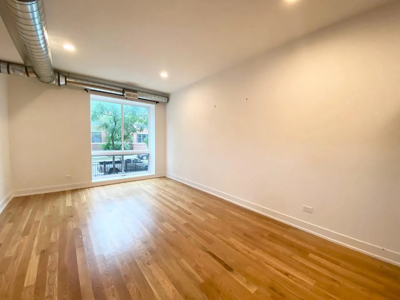 Undisclosed Address Chicago, IL 60640 - Photo 9 of 16 an empty room with wooden floor and windows