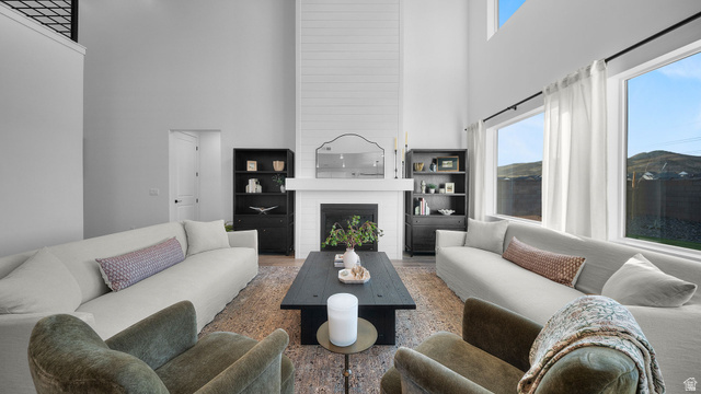 324 North Rhyolite Drive, Unit 87 Hurricane, UT 84737 - Photo 9 of 33 Living room with a high ceiling, a fireplace, and wood finished floors